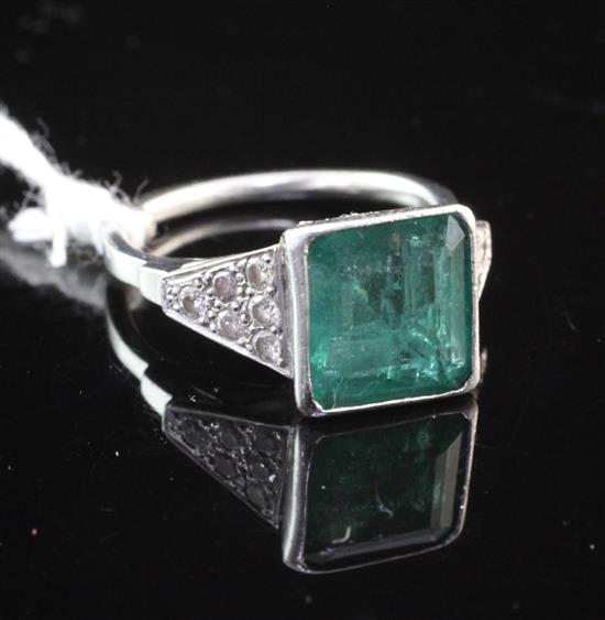 A platinum, emerald and diamond ring, size L.